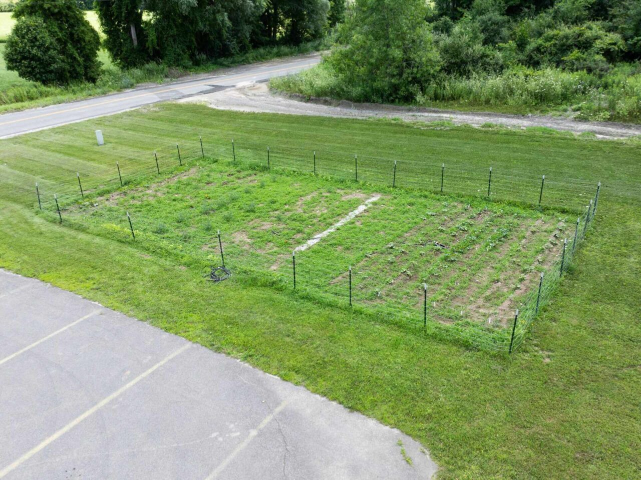 A fenced green space showing sustainable efforts by Barrett Paving in Clayville to reduce our carbon footprint.