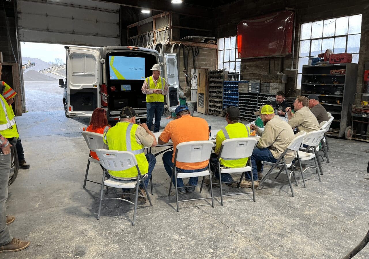 Team meeting at Barrett Midwest Division, discussing the 2025 Road Map, celebrating Earth Day initiatives.