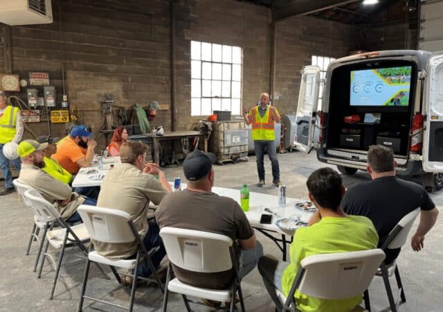 Barrett Midwest Division employees attend a presentation in a workshop, celebrating Earth Day.