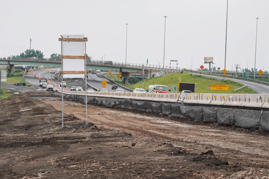 Route 695 reconstruction in progress, showing traffic cones and vehicles managed by Barrett Paving.